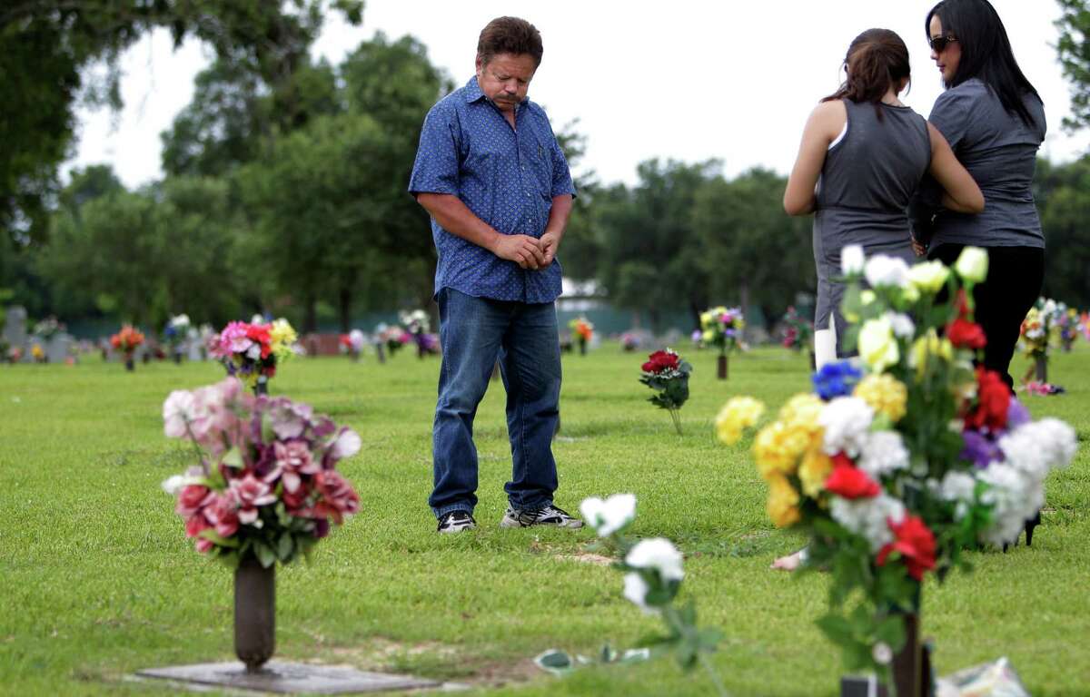 Guillermo Gomez of Houston sighs while visiting the grave site of his wife Vilma Marenco on July 15, 2014. Marenco was driving home after working the lunch shift at Pappasito’s when an oilfield hauling truck loaded with heavy pipe ran a red light and crushed the passenger side of her Chevy Cavalier. Marenco was killed at the scene of the accident, an industrial intersection near her home. Inspection reports show the trucking firm had been targeted for state enforcement but kept operating without a state license. The truck that killed Marenco had at least a dozen defects and was not road-worthy, a post-accident inspection shows.