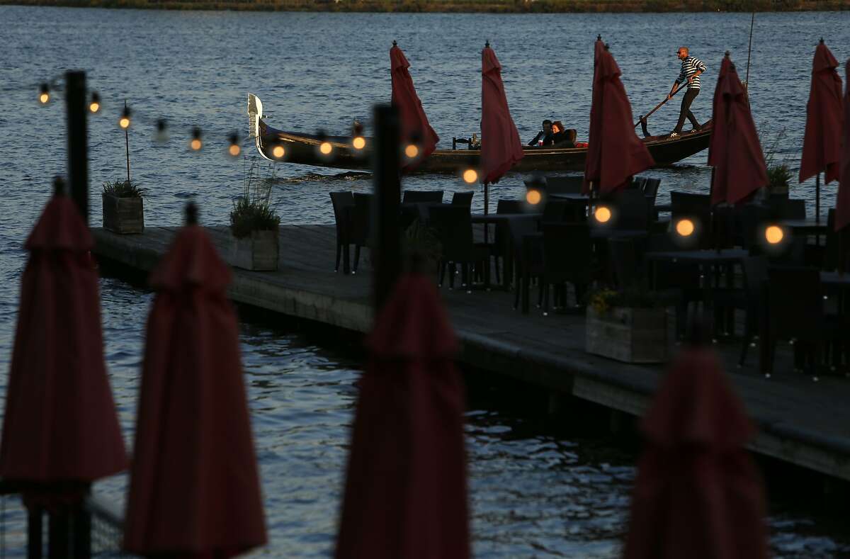 A gondola from Gondola Servizio arrives back at the Lake Chalet Seafood Bar & Grill on Lake Merritt in Oakland, Calif. on Wednesday, September 10, 2014.