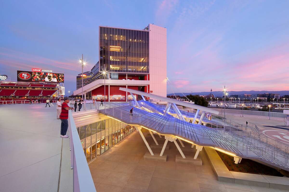 A side view of main entrance, with its roofed-in escalator and the procession of shallow stairs that HNTB architect Fernando Vazquez likens to the ascension toward a Roman amphitheater. Since the pre-season open house where this photo was taken, a large concession stand has been added to the plaza in front of the escalators.