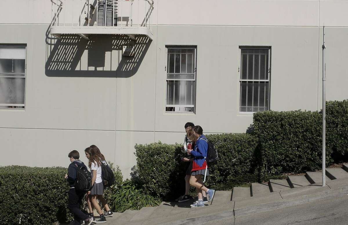 Kids walk down Fillmore st., where there are steps needed to help people walk up and down the hill into the Marina area from the Pac Heights on Fillmore st. in San Francisco, Calif., on Friday, September 12, 2014.