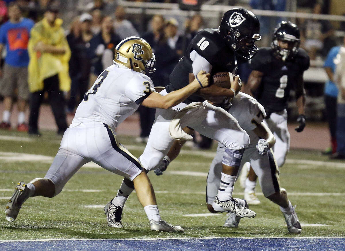 Steele QB L.G. Williams tries to avoid O'Connor's Ronnie Zuniga (left) and Kody Fields (right) during the first half Friday at Lehnhoff Stadium. Williams scored on a 14-yard run in the fourth quarter to help keep the Knights unbeaten.