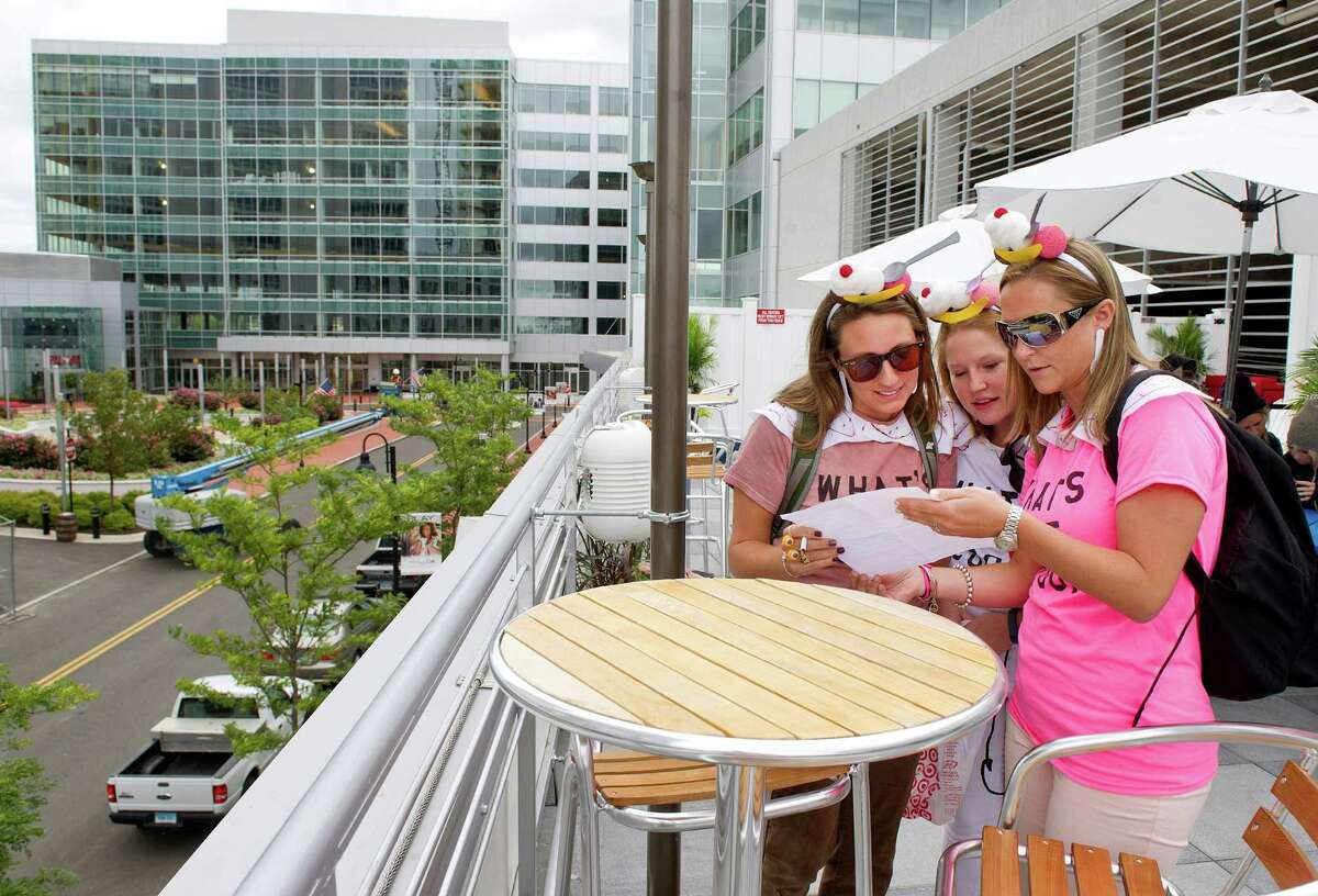From left, Stefanie Suppa, Maureen Mehner, and Kerilyn Whitehead look over the clues during the Urban Scavenger Race at Sign of the Whale at Harbor Point in Stamford, Conn., on Saturday, September 13, 2014.