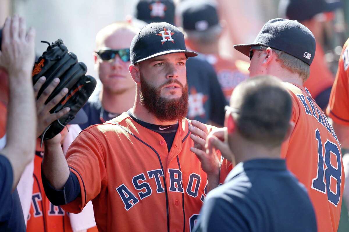 ANAHEIM, CA - SEPTEMBER 14: Starting pitcher Dallas Keuchel #60 of the Houston Astros is greeted in the dugout after being relieved in the eighth inning on a single by Mike Trout of the Los Angeles Angels of Anaheim at Angel Stadium of Anaheim on September 14, 2014 in Anaheim, California.