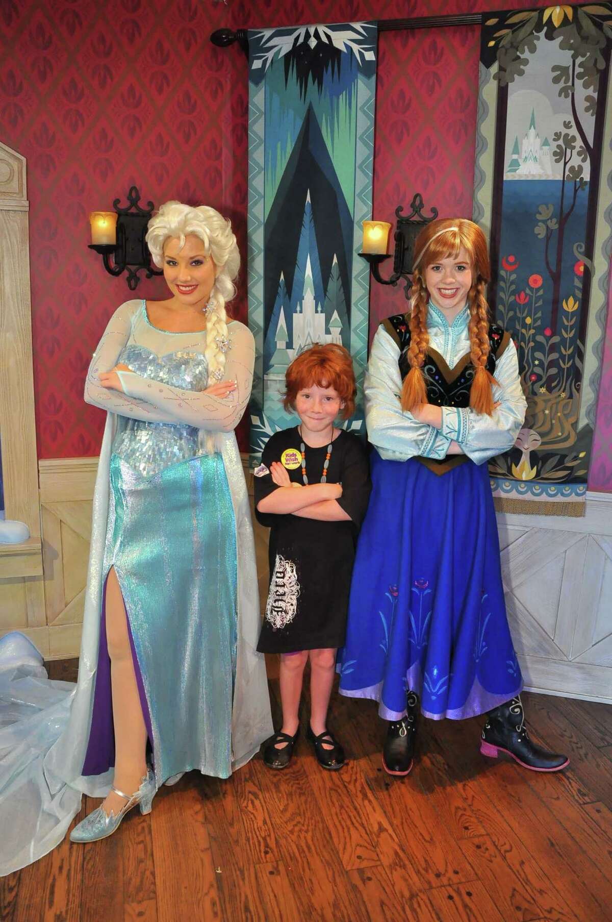 Emileigh Marsh (center) with Elsa and Ana impersonators from the movie Frozen at Disneyland in California.