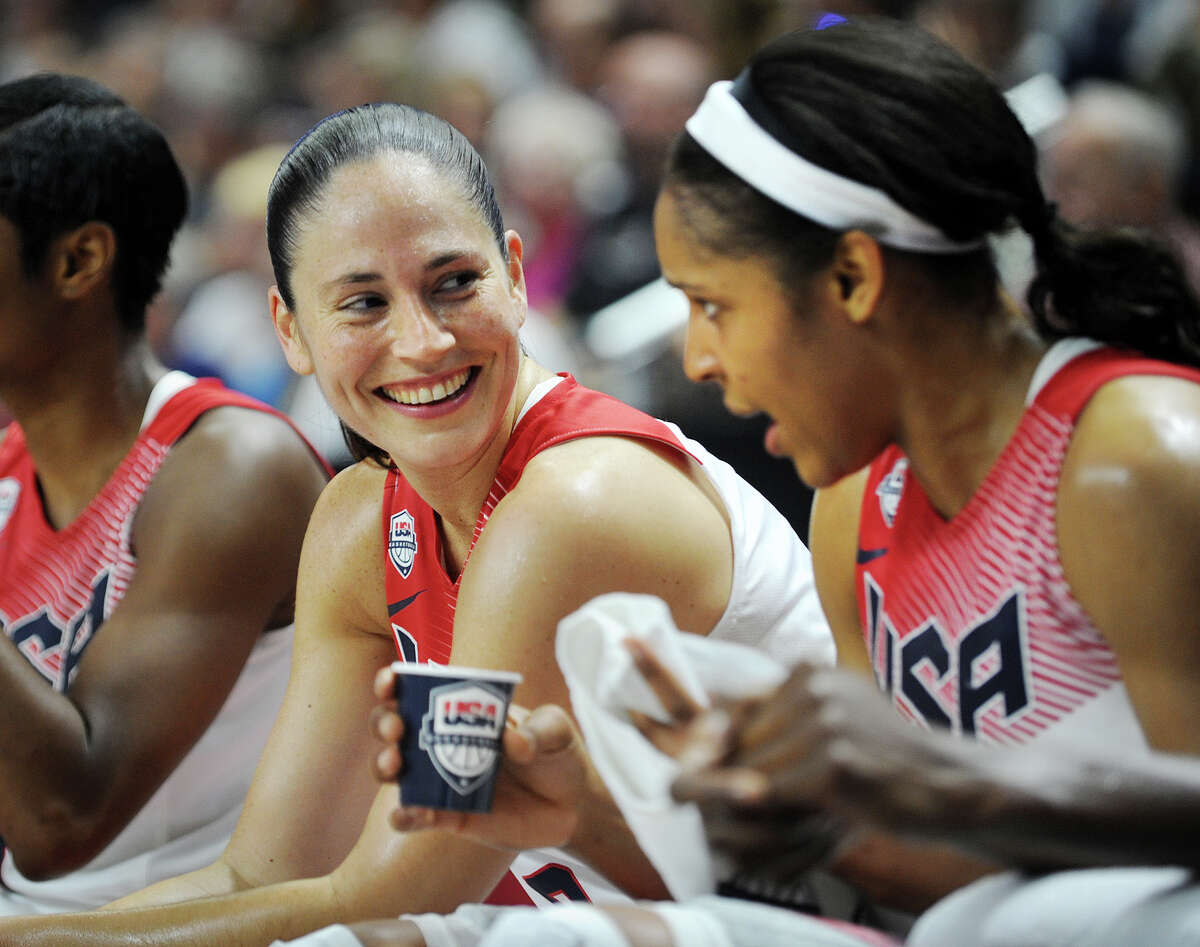 Former UCONN women's basketball stars Sue Bird, left, and Maya Moore chat as they catch a breather on the bench during Team USA's matchup with Team Canada at the Webster Bank Arena in Bridgeport, Conn. on Monday, September 15, 2014.
