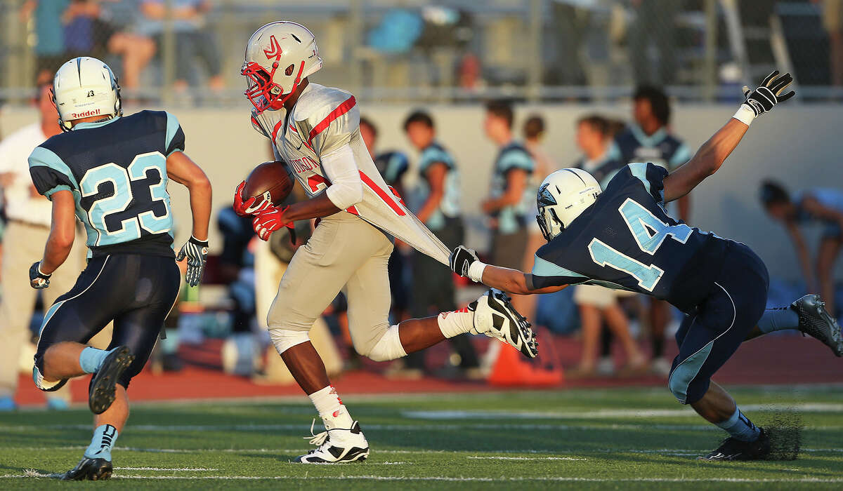 Rocket running back Malik Taylor is slowed up by Hunter Williams (14) and then brought down by Daniel Robertson (23) as Judson hosts Johnson at Rutledge Stadium on September 11, 2014.