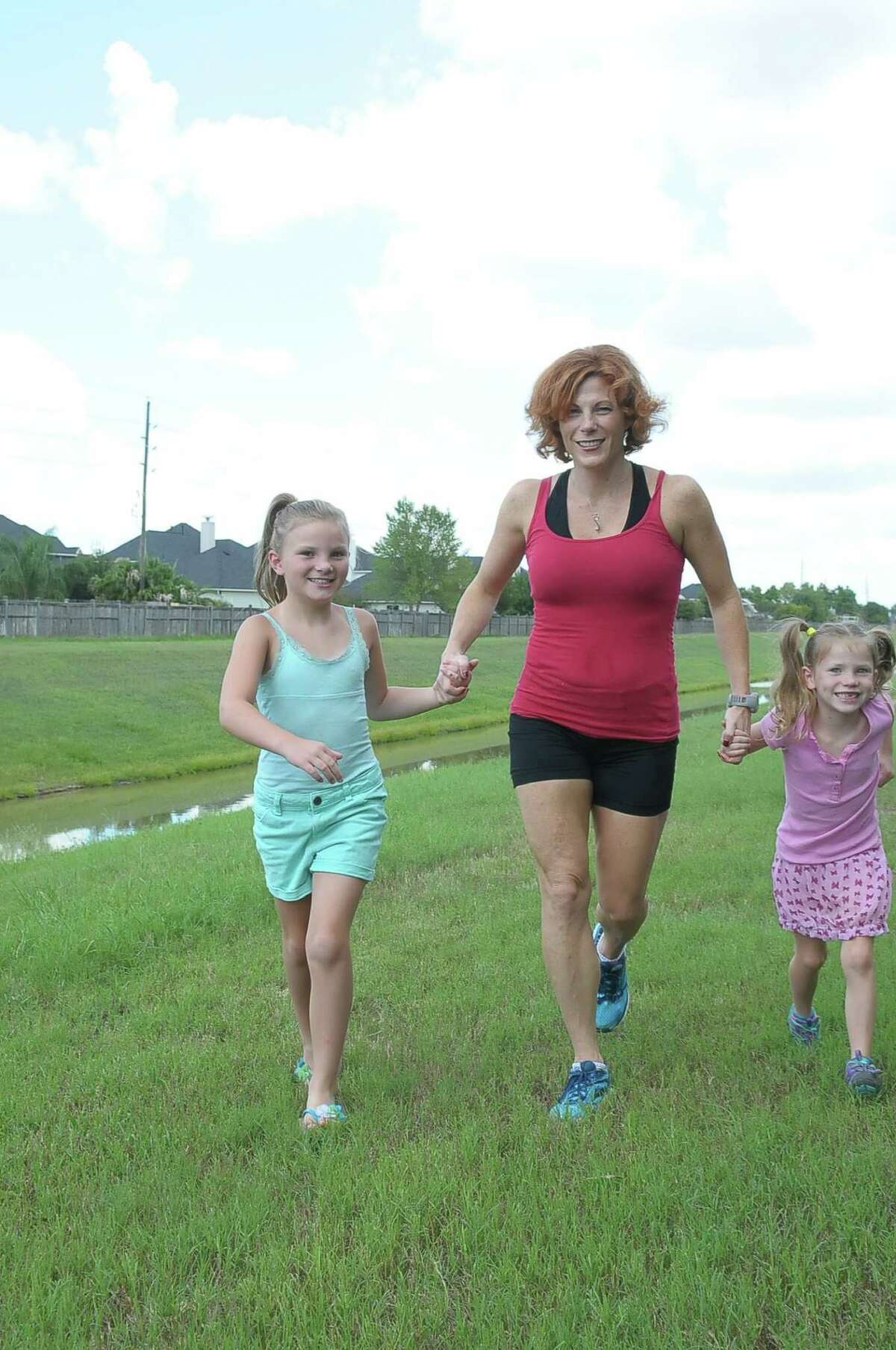 Kimberly Rensel runs with her daughters Sadie Rensel, 7½, and Savannah Rensel, 6, near their home in Katy. She is running to raise money to go on a mission to Africa. Kimberly Rensel runs with her daughters Sadie Rensel, 7½, and Savannah Rensel, 6, near their home in Katy. She is running to raise money to go on a mission to Africa.
