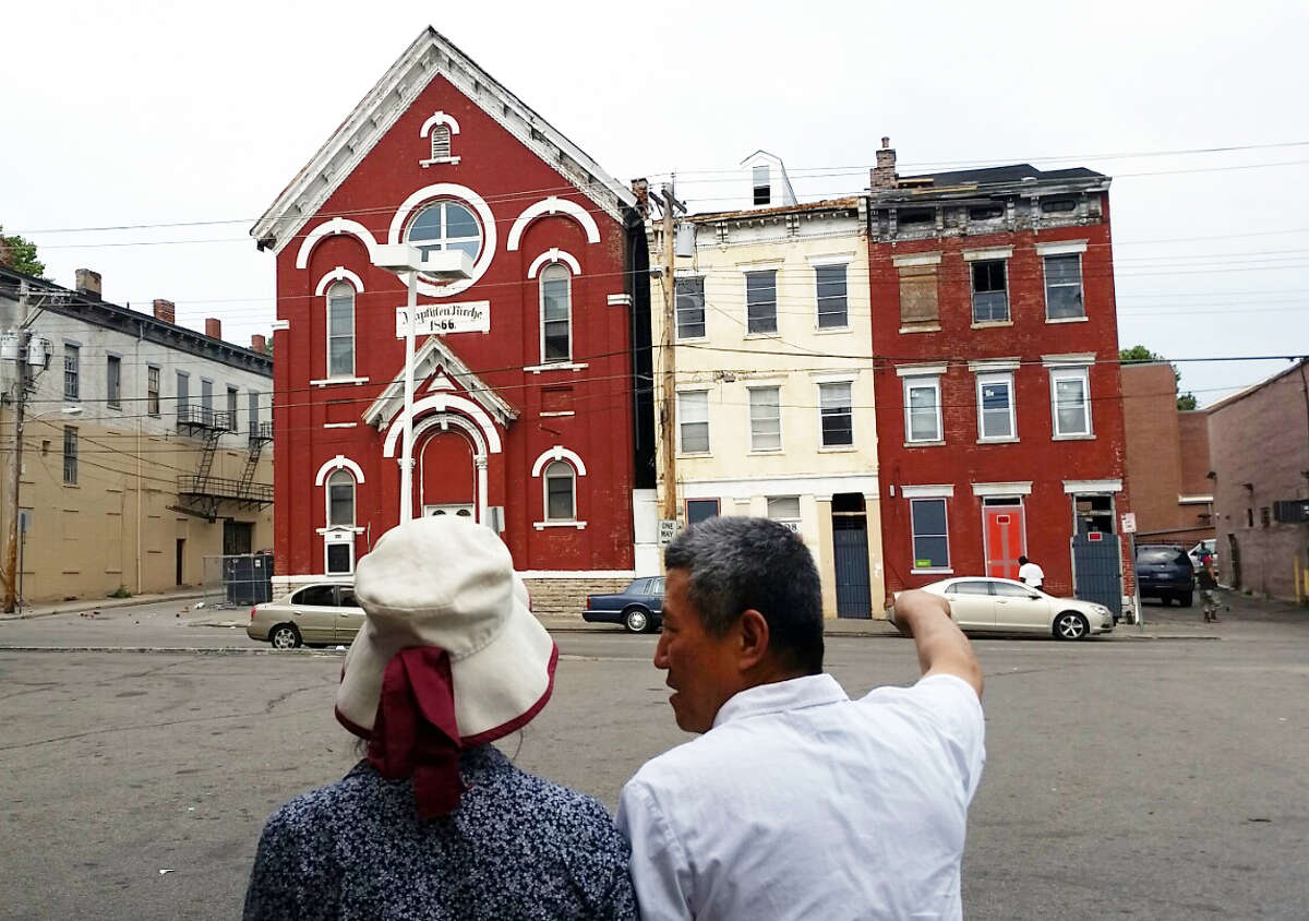 Pastor Johann Kim and Sister Grace look to the site of their new church building in Bridgeport, Conn. photo Crystal Kang/ Fairfield County Business Journal