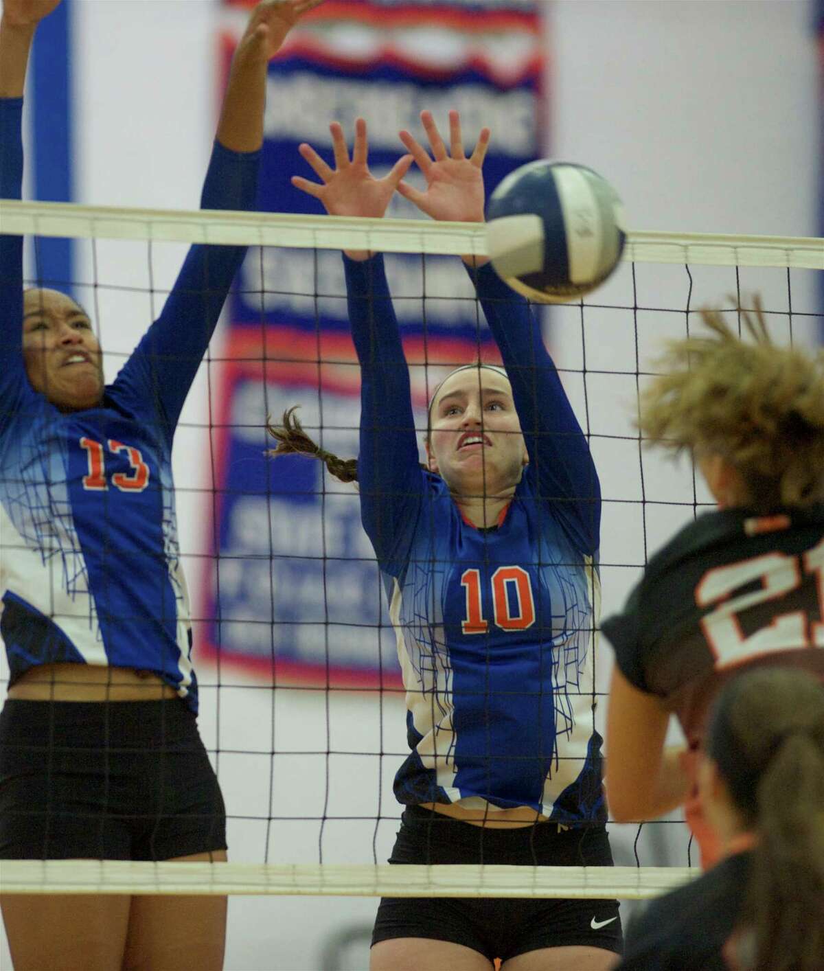 Danbury's Philecia Seipio, 13, and Shannon Geary, 10, go up for the block against Stamford's Anne Eilertsen during the Stamford High School and Danbury High School girls volleyball match, played at Danbury High School, Danbury, Conn, on Wednesday, September 17, 2014. Stamford won the match 3 games to 1.