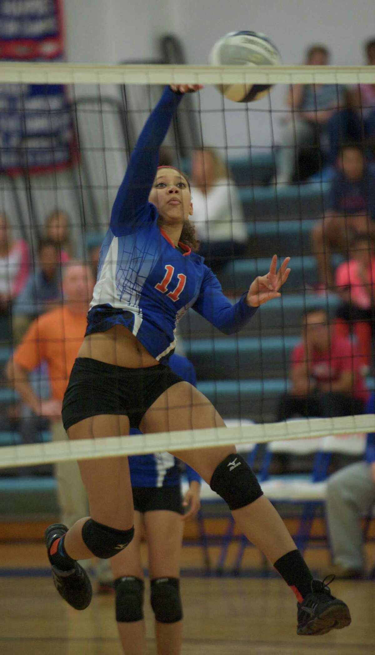 Danbury's Jocelyn Perez, 11, spikes the ball during the Stamford High School and Danbury High School girls volleyball match, played at Danbury High School, Danbury, Conn, on Wednesday, September 17, 2014. Stamford won the match 3 games to 1.