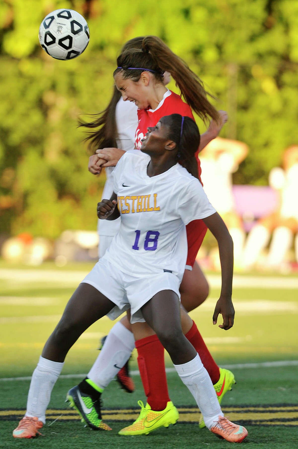 Westhill's Chelsea Domond and Greenwich's Katherine Doyle compete for the header during their game at Westhill High School in Stamford, Conn., on Wednesday, Sept. 17, 2014. Westhill won, 2-1.