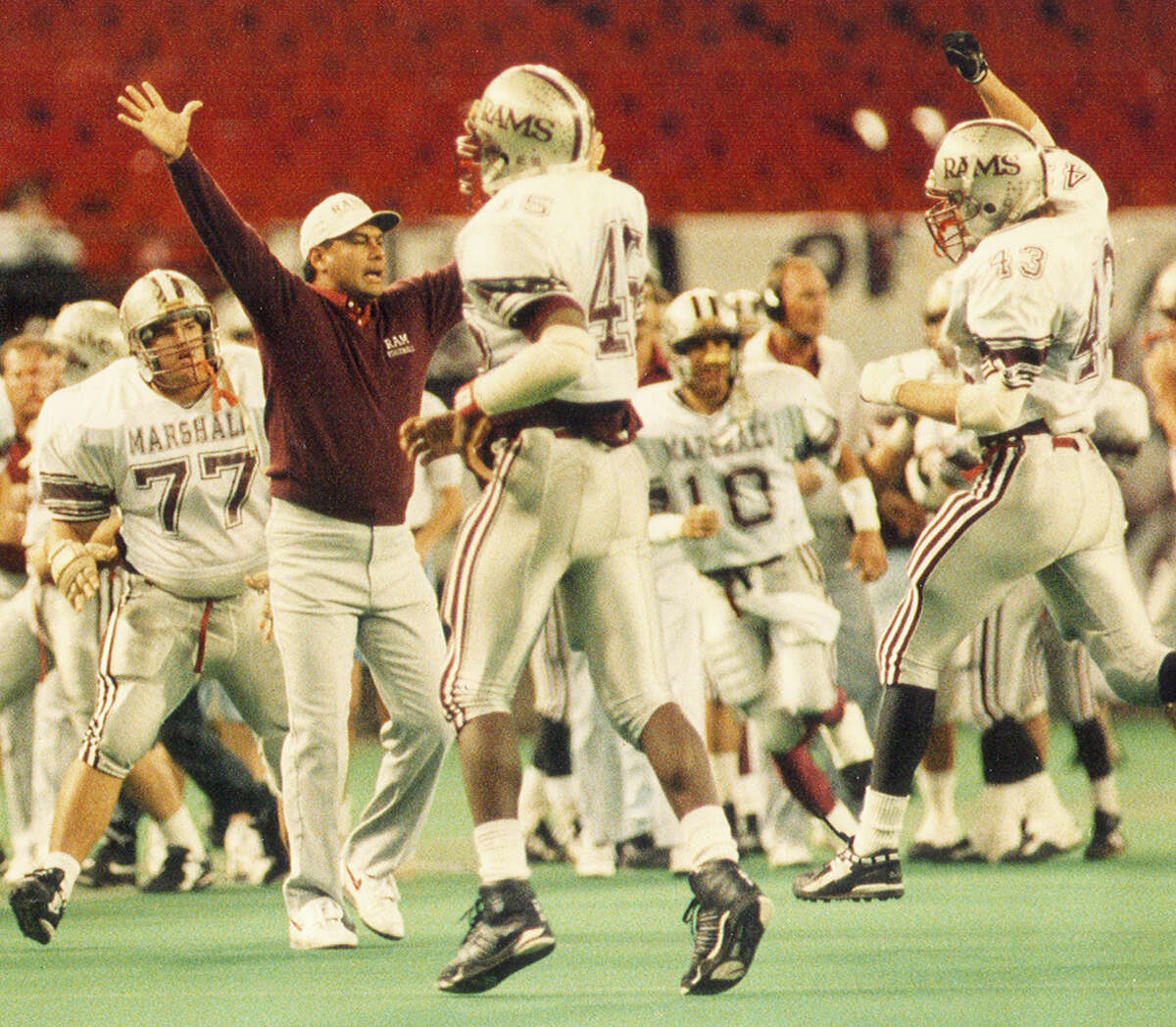 Marshall's defense runs off the field during a 5A semifinal victory over Aldine in 1991 at Houston's Astrodome.