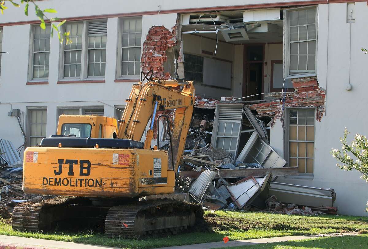 A parked excavator sits outside Wheatley High School as community leaders protest the demolition of the historic Fifth Ward campus Sept. 1.