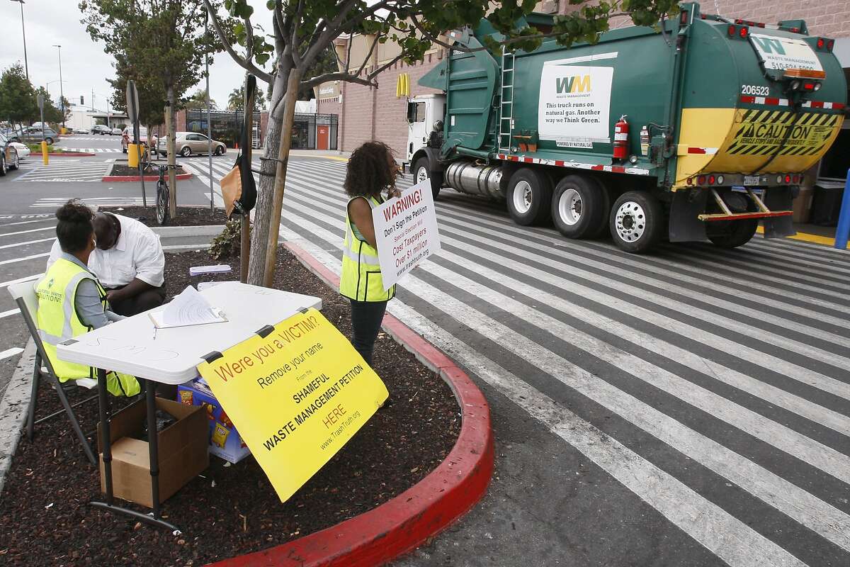 Workers for California Waste Services were asking passersby to withdraw their support for Waste Management's referendum at Walmart on Edgewater Drive in Oakland on Thursday.
