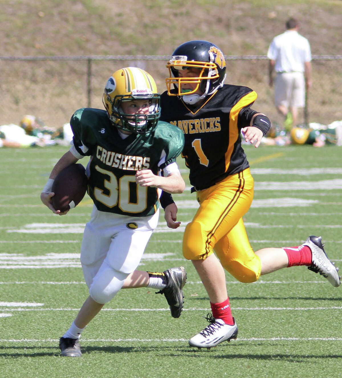 The Crushers' Will Grimes runs away from the Mavericks' defense.