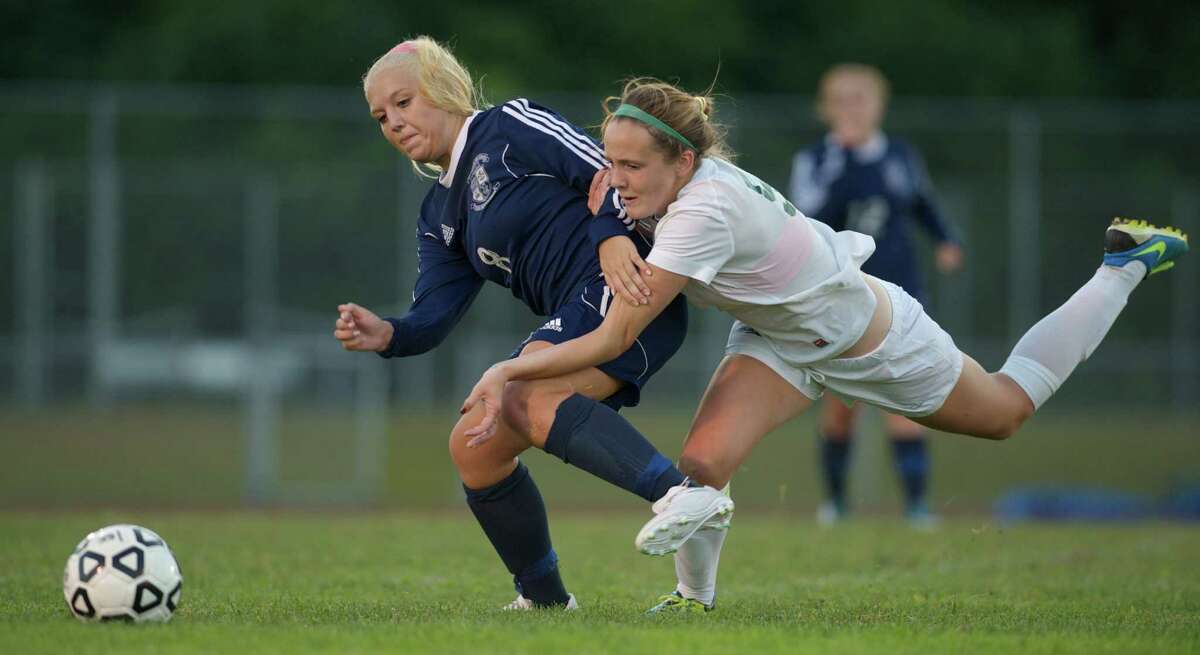 Immaculate senior Rachael Raffini (8) and New Milford senior Rachel Weir (5) get tangled up while going for the ball during a girls soccer game between Immaculate High School and New Milford High School on Thursday, September, 18, 2014. Played in New Milford, Conn.