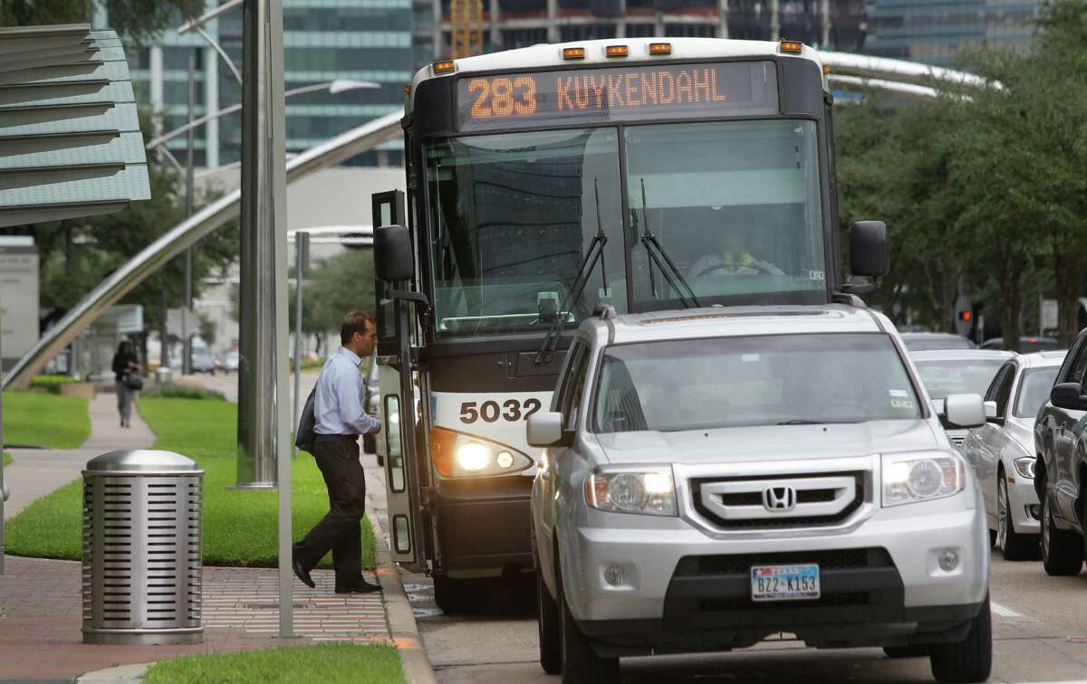 A passenger boards a Metro bus along Post Oak near Westheimer Thursday, Sept. 18, 2014, in Houston.