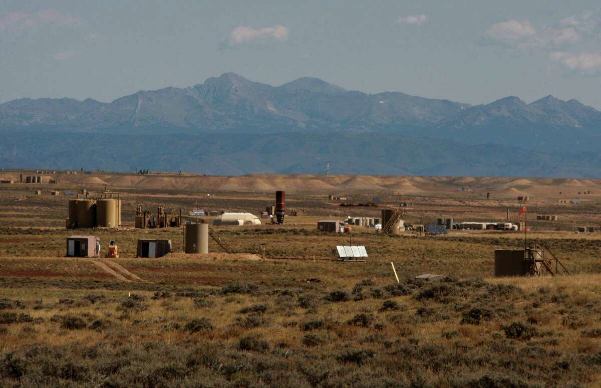 Natural gas wellhead huts, central delivery points and other infrastructure dot the Jonah Field on Monday, Sept. 8, 2014 near Pinedale, Wyo. Jonah Energy recently acquired Encana's natural gas assets in the area. (AP Photo/Casper Star-Tribune, Alan Rogers)
