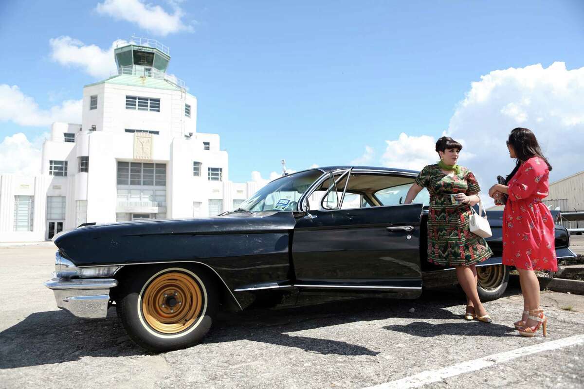 Natty D'Light shows her Cadillac Series '62 to designer and judge Chloe Dao outside the Houston Vintage Show held at the 1940 Air Terminal Museum on Saturday, Sept. 20, 2014, in Houston.