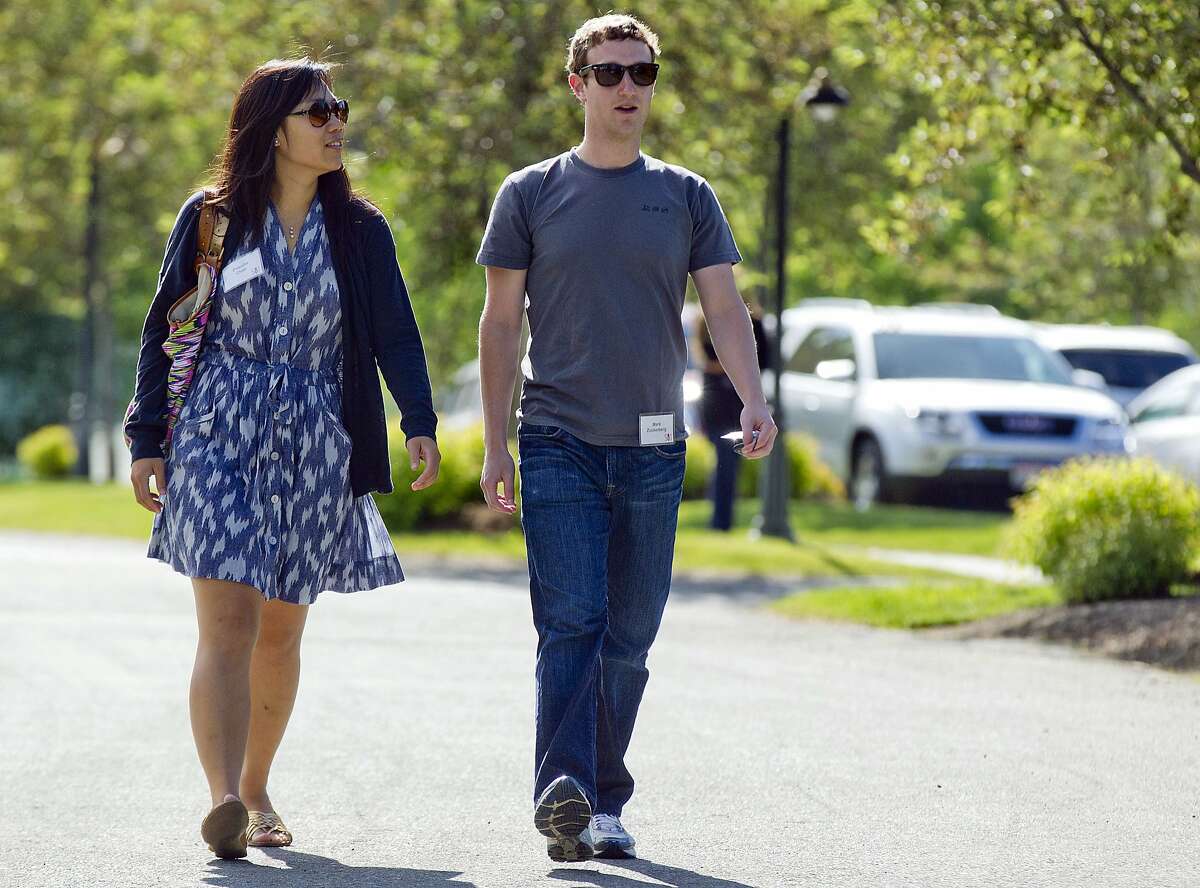 In this July 9, 2011, file photo, Mark Zuckerberg, president and CEO of Facebook, walks to morning sessions with his then girlfriend Priscilla Chan during the 2011 Allen and Co. Sun Valley Conference, in Sun Valley, Idaho.