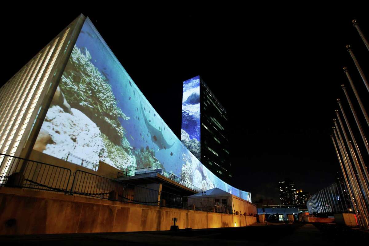 An architectural light show entitled illUmiNations: Protecting Our Planet, designed to inspire action on climate change, is projected on the side of United Nations headquarters Saturday, Sept. 20, 2014. More than 120 world leaders convene Tuesday for a U.N. summit aimed at galvanizing political will for a new global climate treaty by the end of 2015. (AP Photo/Jason DeCrow)
