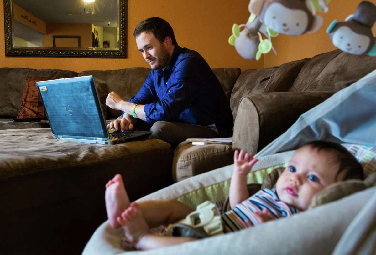 Full-time worker John Flores, 32, studying at home in Angleton with his son, Silas, 3 months, earned a bachelor's degree at Western Governors University in a year and a half. He's now working on his master's.﻿