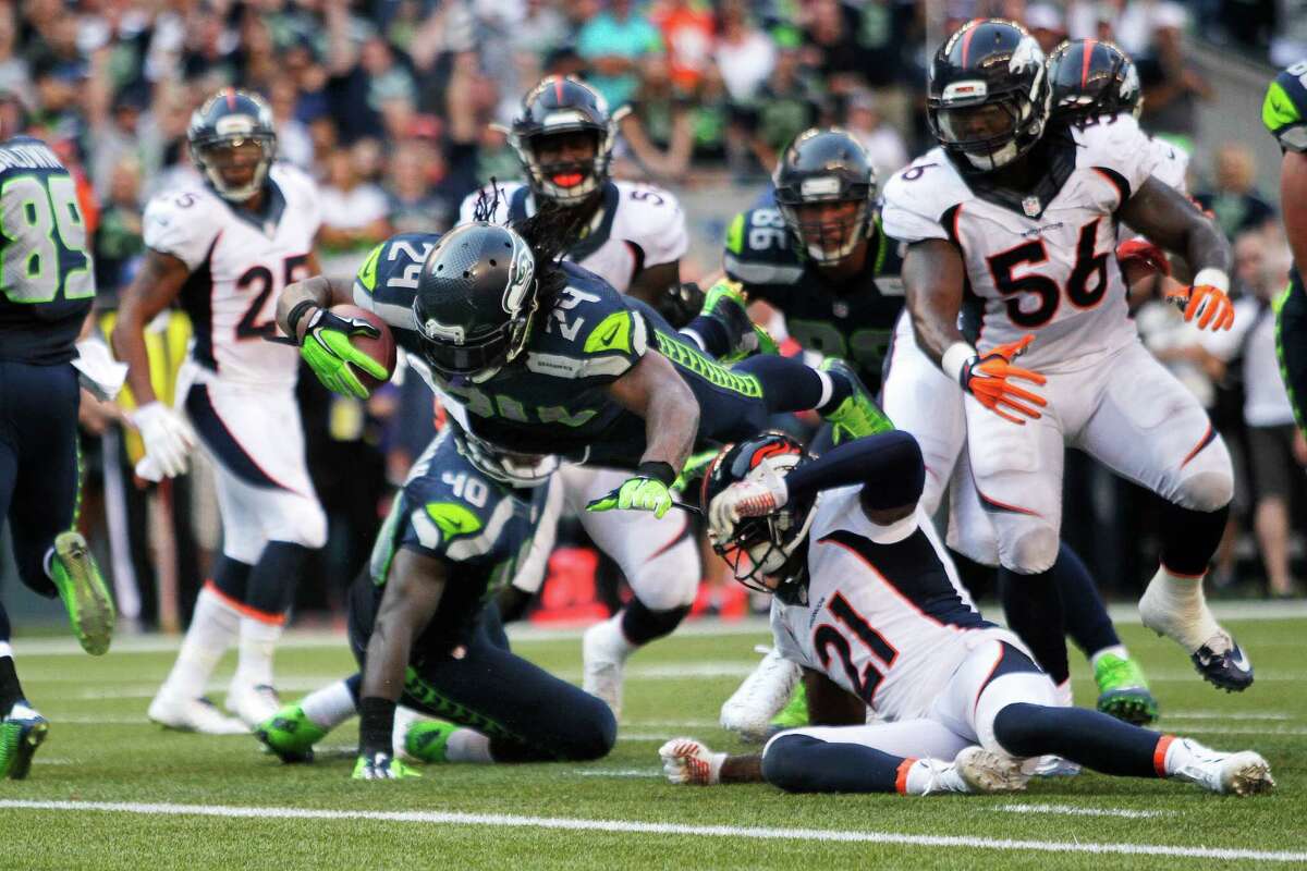 Seattle Seahawks running back Marshawn Lynch dives in for the game-winning touchdown in overtime of an NFL football game against the Denver Broncos, Sunday, Sept. 21, 2014, in Seattle. The Seahawks defeated the Broncos 26-20. (AP Photo/John Froschauer) ORG XMIT: SEA153