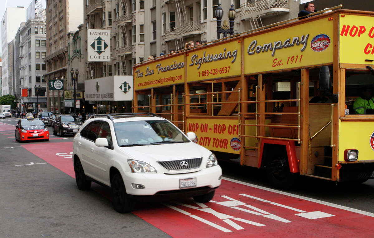An Uber driver rides in a transit lane on Geary Street in San Francisco, a practice opposed by traditional taxi drivers.