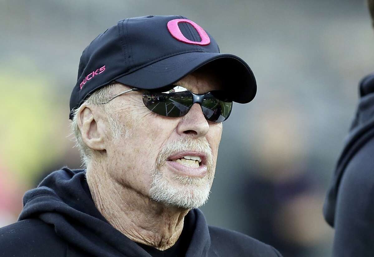 Nike founder and Oregon alumni Phil Knight sports a pink Oregon hat on the sidelines before an NCAA college football game against Washington State in Eugene, Ore., Saturday, Oct. 19, 2013. (AP Photo/Don Ryan)