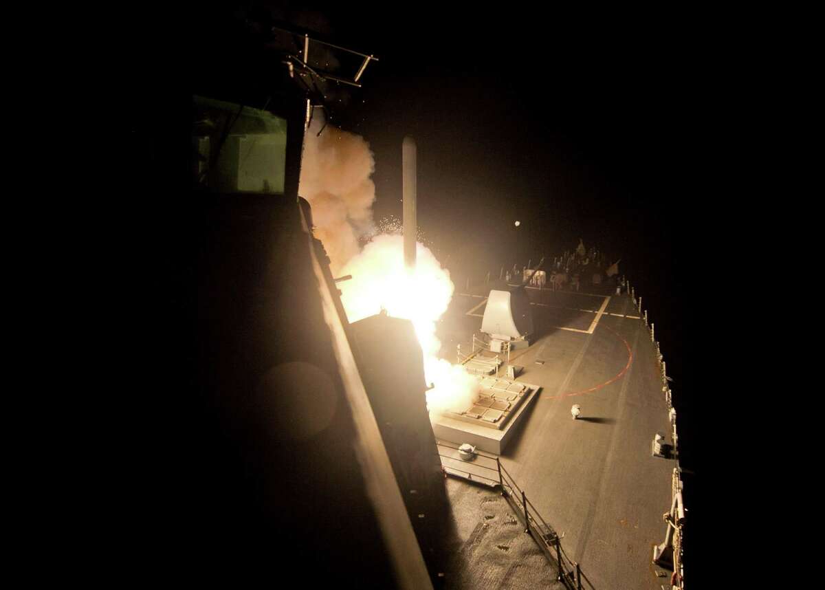 In this image provided by the U.S. Navy, the guided-missile destroyer USS Arleigh Burke (DDG 51) launches Tomahawk cruise missiles on Tuesday, Sept. 23 ,2014, from the Red Sea against Islamic State group targets in Syria.