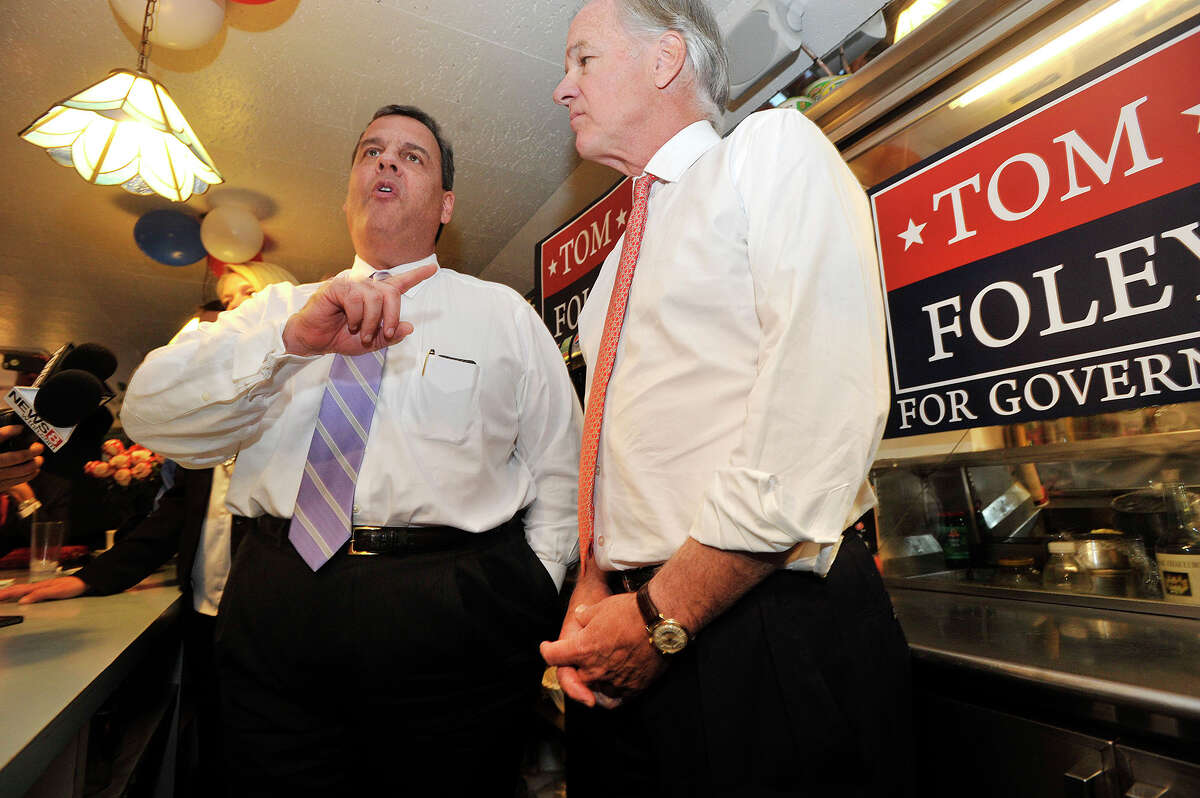New Jersey Gov. Chris Christie, left, answers questions from the media while stumping for Connecticut gubernatorial candidate Tom Foley, right, at Curley's Diner in Stamford, Conn., on Tuesday, Sept. 23, 2014.
