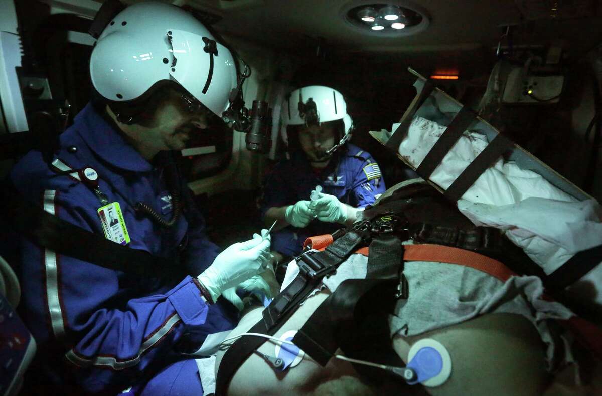 Air Life flight nurse Shawn Russell (left) and flight medic Mike Boulding tend to a patient headed from Nixon to San Antonio in February. At the time, Air Life had been seeing a rise in calls involving trauma victims in the Eagle Ford Shale.