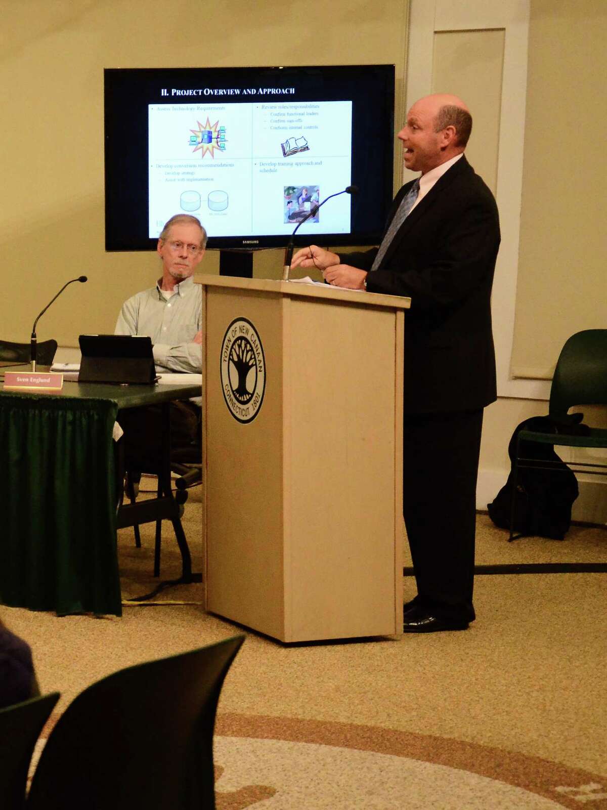 Jeffrey Ziplow, a partner with Blum Shapiro and consultant for the Town of New Canaan, Conn., speaks about Munis, a financial accounting system that will replace the current one used by the town, during a Town Council meeting Wednesday, Sept. 17, 2014, at the New Canaan Nature Center. Pictured on the left, Councilman Sven Englund.