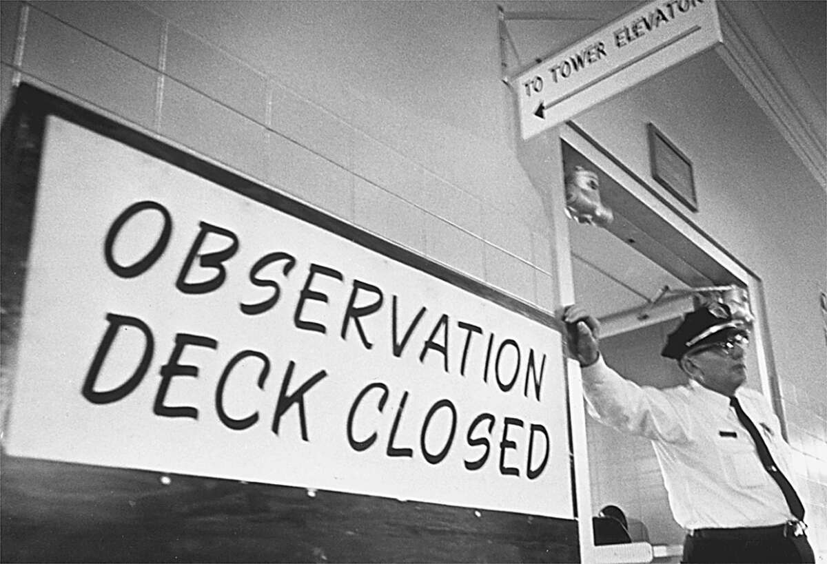 In 1967, a campus police officer keeps visitors out the UT tower's observation deck, which had been temporarily closed. A year earlier, Charles Whitman killed 14 people in and from the tower.