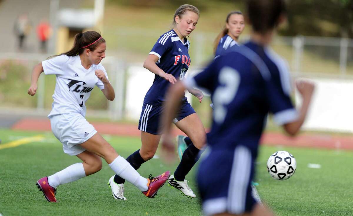 Law's Bethany Edwards drives the ball down the field on her way to a goal during their game against Foran Wednesday, Sept. 24, 2014, at Jonathan Law High School in Milford, Conn.