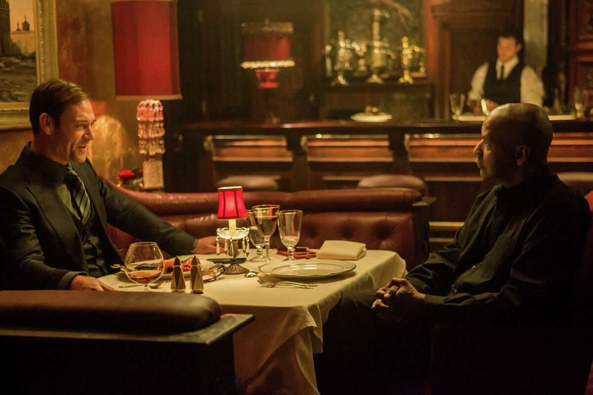 Despite the civilized scene, expect Teddy (Marton Csokas, left) and Robert McCall (Denzel Washington) to butt heads in “The Equalizer.”