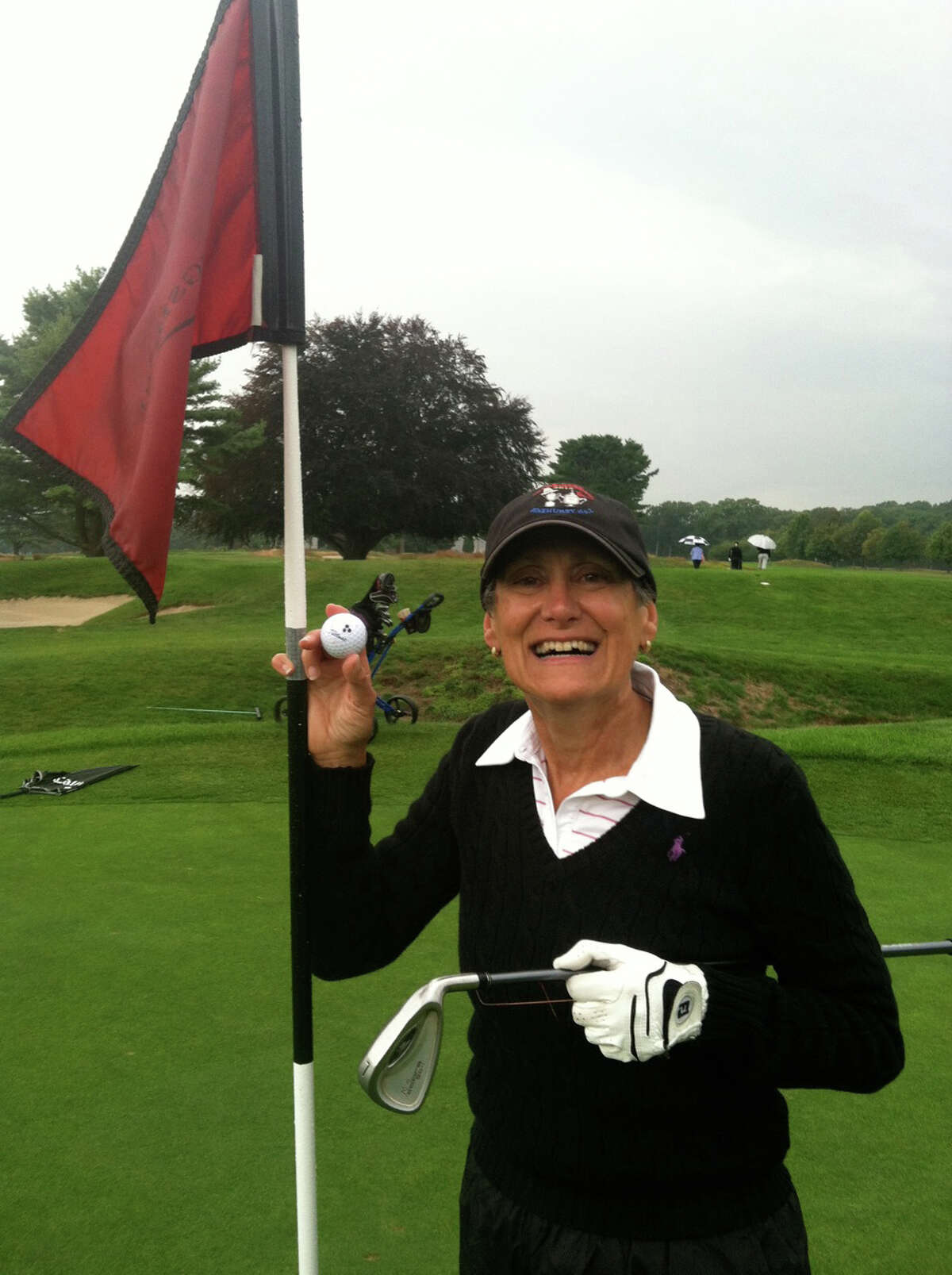 Alison Tane celebrates a hole-in-one on the eighth hole at Longshore during the Longshire Women's Golf Association event on Tuesday. Tane hit a 7-iron on the 123-yard hole.