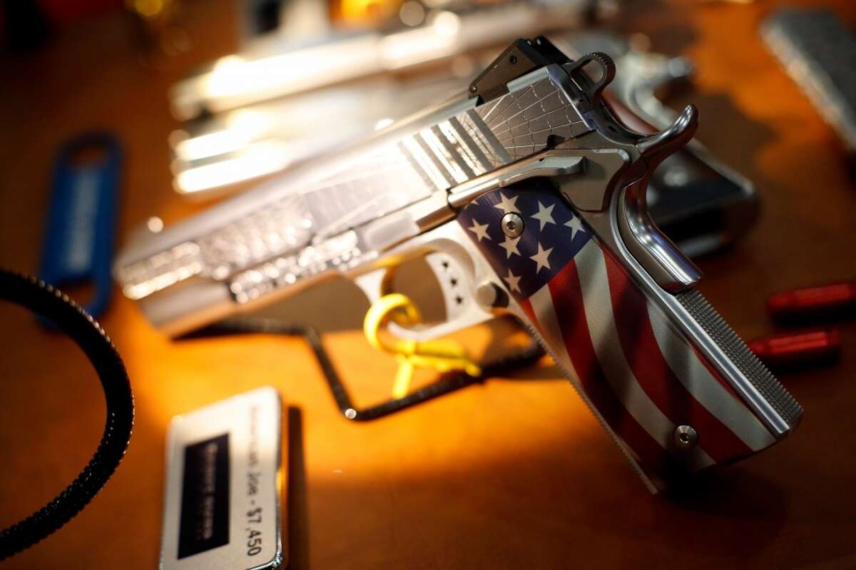 1. Are you buying the gun for yourself, or is it actually for someone else? A decorative pistol is seen, during a 2013 NRA meeting in Houston at the George R Brown convention center. (TODD SPOTH FOR THE CHRONICLE)