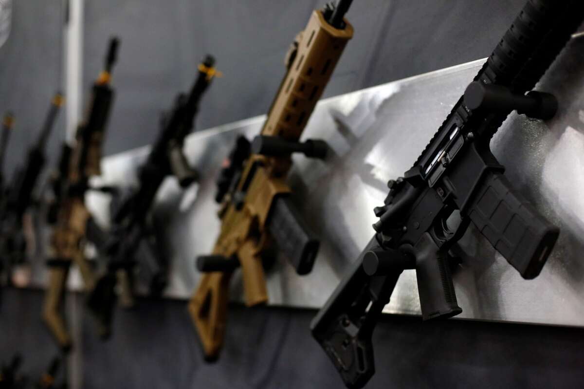3. Are you a fugitive? A wall of rifles is seen, during a 2013 NRA meeting in Houston at the George R Brown convention center. (TODD SPOTH FOR THE CHRONICLE)