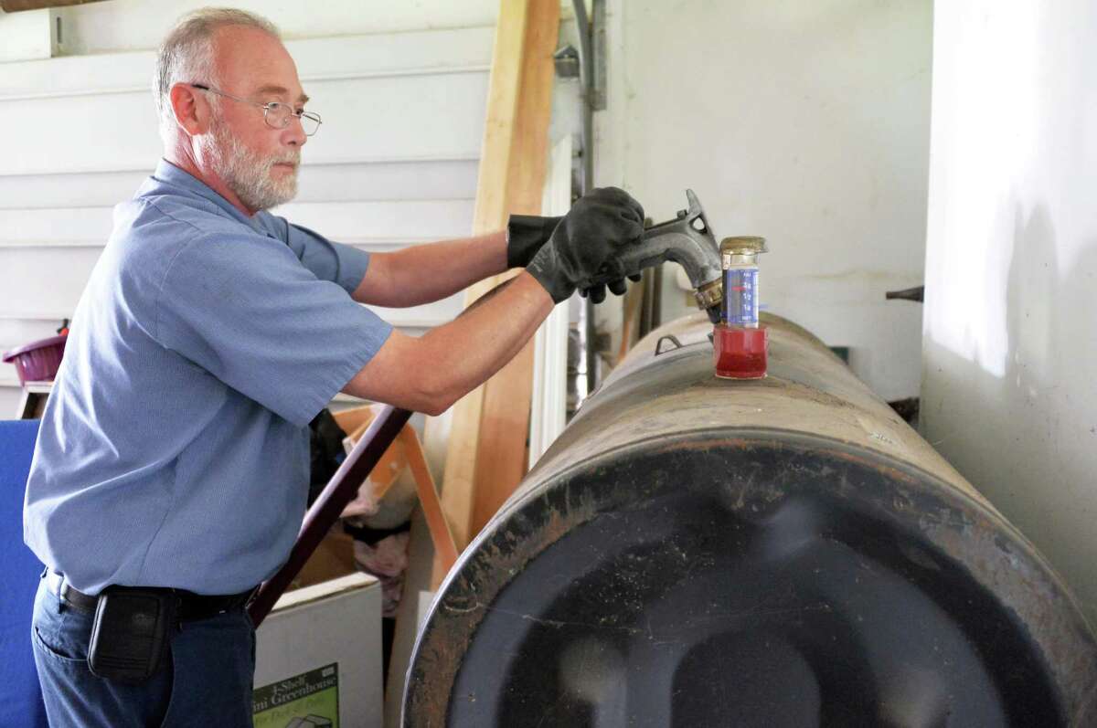 Heating oil delivery driver Glenn Hotaling of Family Danz Heating and Cooling delivers heating oil to a home Thursday Sept. 25, 2014, in Castleton, NY. (John Carl D'Annibale / Times Union)