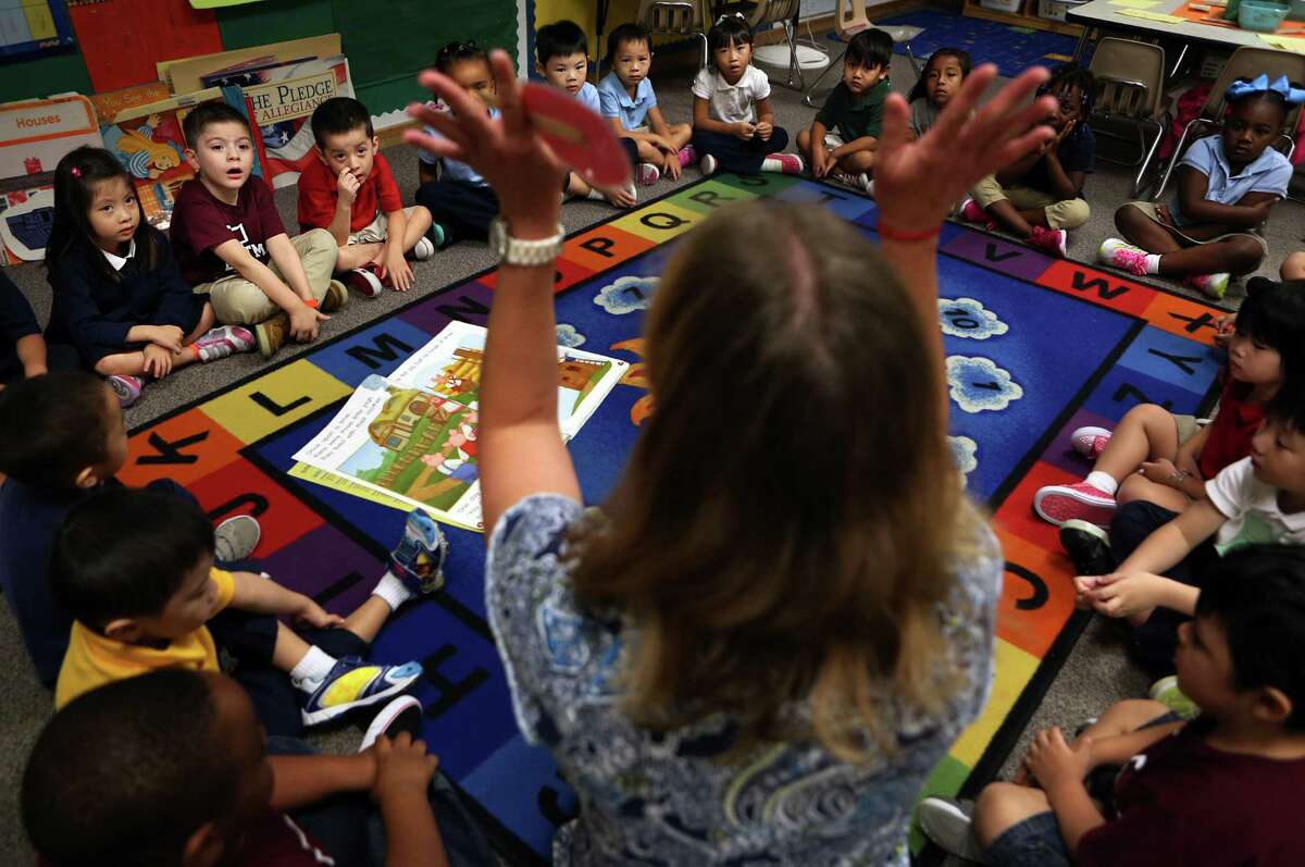 Pre-kindergarteners listen to teacher Lisa Joe as she tells a story during their morning lesson at Liestman Elementary School on Wednesday, Sept. 24, 2014, in Houston. 