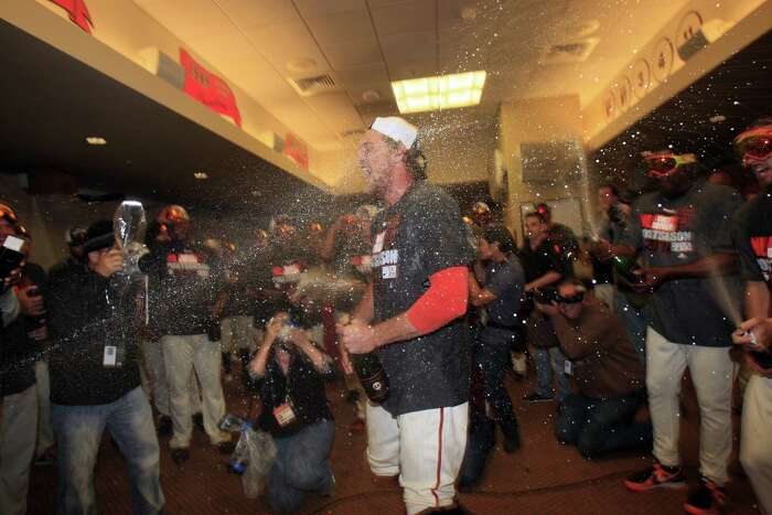 Joe Panik hugs his girlfriend Brittany Pinto in the locker room