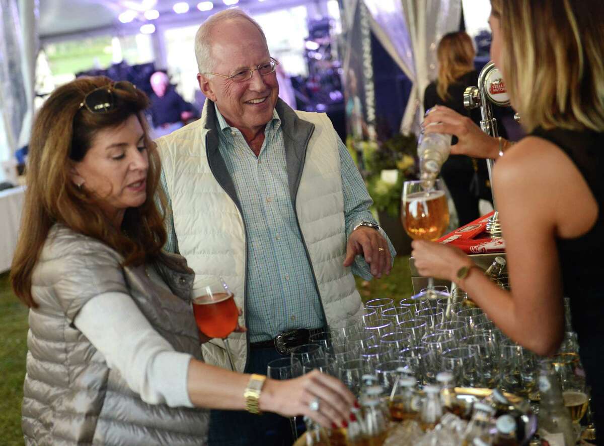 Schuiler and Charlie Hinnant, of Rowayton, try a glass of Stella Artois during day two of the Greenwich Wine + Food Festival at Roger Sherman Baldwin Park in Greenwich, Conn. Friday, Sept. 26, 2014. Friday night's festivities included the 2014 Most Innovative Chefs Gala featuring special guest culinary masters Geoffrey Zakarian and Jean-Georges. The night concluded with a performance by southern classic rock band The Marshall Tucker Band. The festival continues Saturday starting at noon, with live music featuring Alabama from 6:30 to 10 p.m.