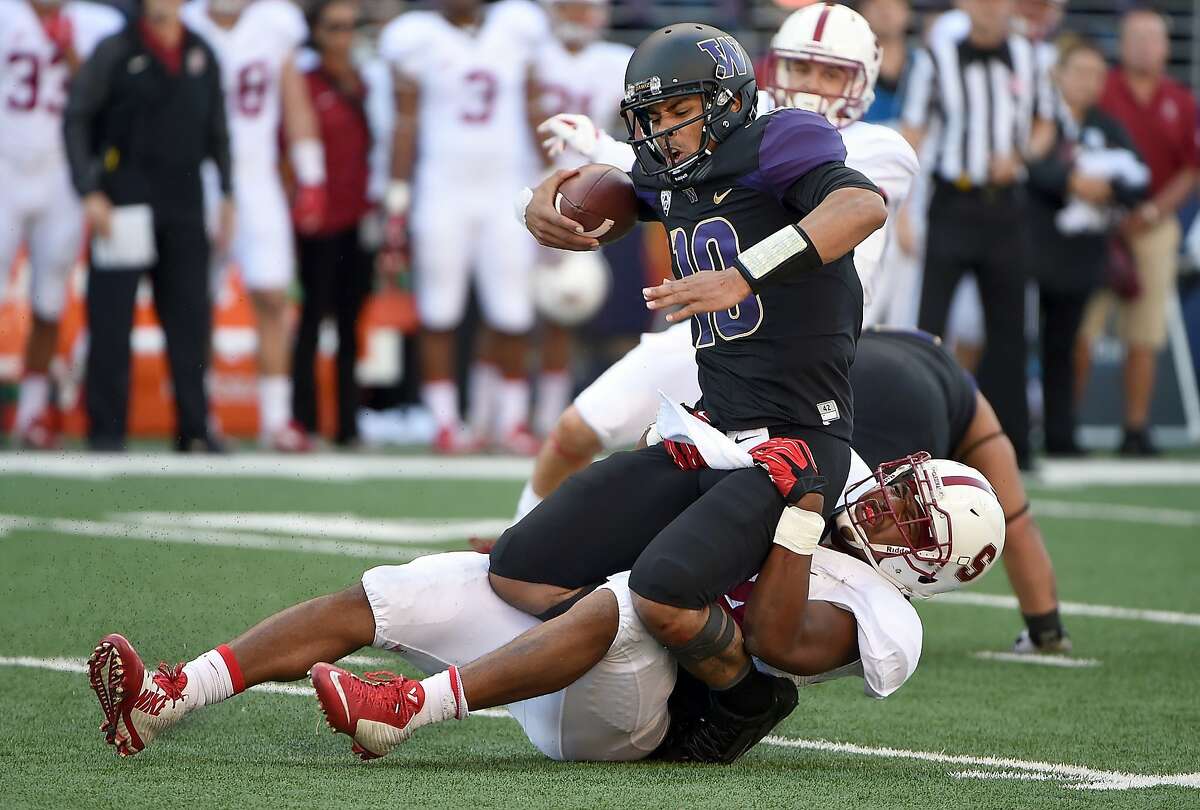 SEATTLE, WA - SEPTEMBER 27: Quarterback Cyler Miles #10 of the Washington Huskies is sacked by linebacker Peter Kalambayi #34 of the Stanford Cardinal during the second quarter of the game at Husky Stadium on September 27, 2014 in Seattle, Washington. (Photo by Steve Dykes/Getty Images)