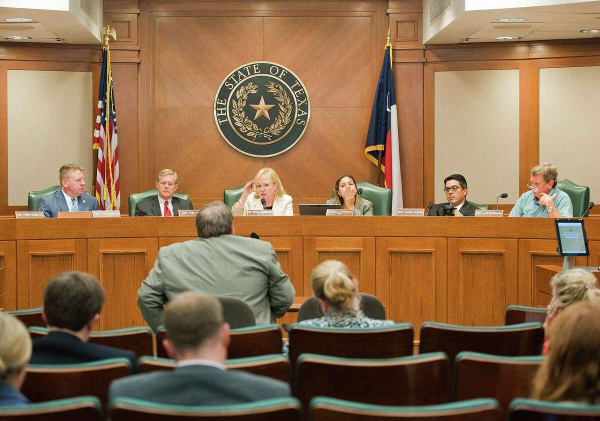 Dr. Craig Pearson, center, seismologist for the Texas Railroad Commission, speaks during a meeting by the state House Energy Subcommittee on Seismic Activity at the Texas state capitol on Mon.Aug. 24, 2014. Ashley Landis / For the Chronicle