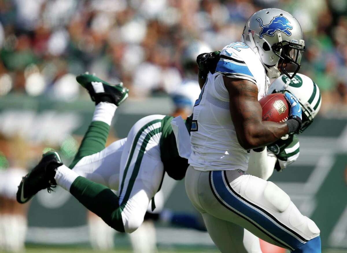 Detroit Lions wide receiver Jeremy Ross, front, avoids a tackle attempt by New York Jets cornerback Antonio Allen while scoring on a pass from quarterback Matthew Stafford during the first half of an NFL football game, Sunday, Sept. 28, 2014, in East Rutherford, N.J. (AP Photo/Kathy Willens) ORG XMIT: ERU106