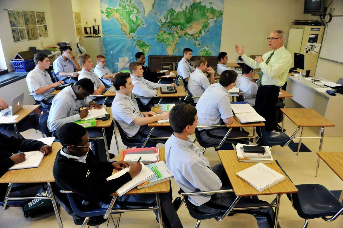 Kenneth Bentley teaches an economics class at LaSalle Institute on Wednesday, Sept. 17, 2014, in Troy, N.Y. The school is doing away with the Regents exams for students in grades 9-12. (Paul Buckowski / Times Union)