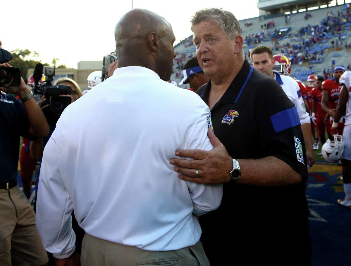 Kansas coach Charlie Weis (right) was fired Sunday, a day after coach Charlie Strong and Texas shut out the Jayhawks. Weis went 6-22 with Kansas.