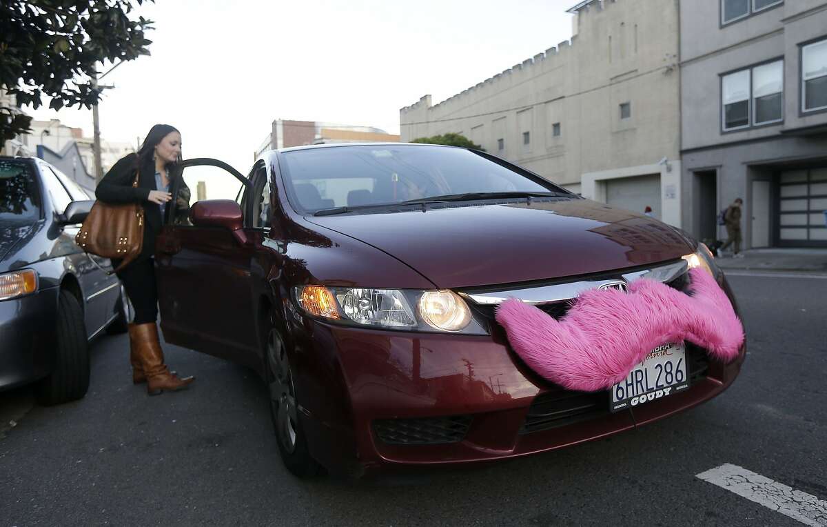 In this Jan. 4, 2013 file photo, Lyft passenger Christina Shatzen gets into a car driven by Nancy Tcheou in San Francisco.