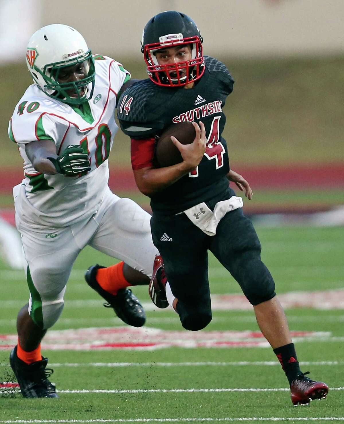 Southside's Marc Garza looks for running room around Sam Houston's Chaye Williams during first half action Saturday Sept. 5, 2014 at Southside High School.